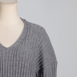 Detailed close-up of grey ribbed knit long-sleeved top showing V-neck and soft texture