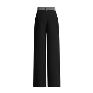 Detail view of high waist wide leg pants featuring black and grey contrast patchwork design