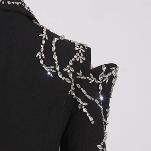 Detail of handcrafted crystals and sequins on a luxury black tailored blazer jacket