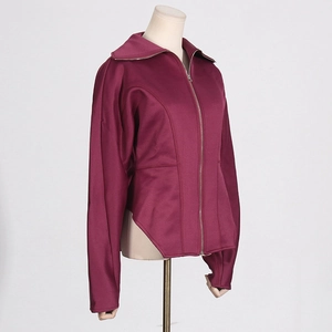 Detail of burgundy zip-up jacket featuring structured waist and unique jagged hemline