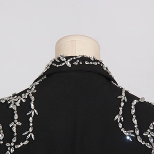 Detail of hand-sewn silver crystals and floral embroidery on a black blazer's collar