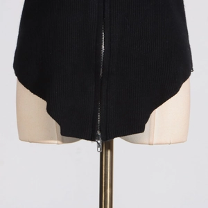 Close-up of black rib-knit fabric texture with a vertical silver metal zipper detail