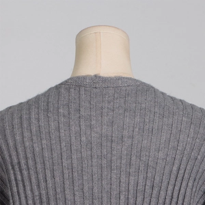 Detailed view of the grey ribbed knit sweater neckline on a beige mannequin bust