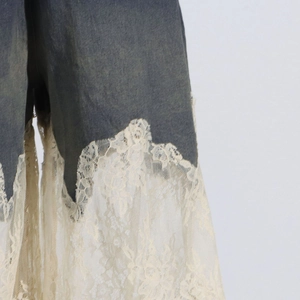 Detail of floral lace patchwork hem on high-quality denim shorts for a boho style