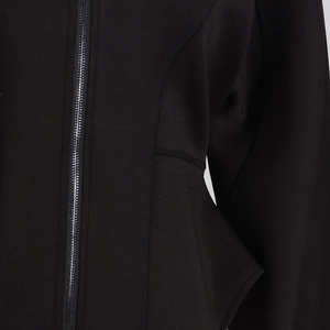 Detail of a black neoprene jacket showing premium metal zipper and slimming seam construction
