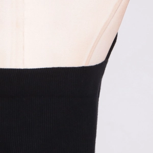 Close-up of black ribbed knit fabric showing detailed vertical texture and elastic material
