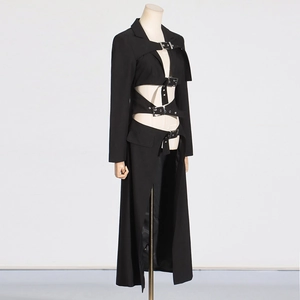 Detail of gothic black trench coat featuring hollow-out waist and metal buckle belts