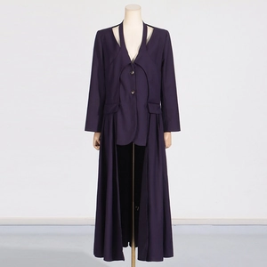 Detail of deep purple long trench coat with unique cutout collar and pleated skirt hem