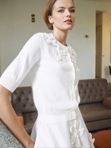 Elegant white knit cardigan and skirt set with 3D floral appliqués for a chic style