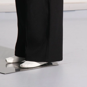 Detail view of the straight leg trousers hem with premium draping fabric in black