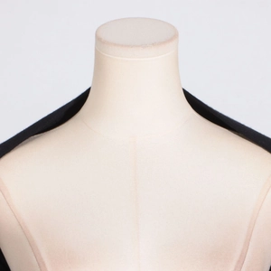 Detail shot of black halter neck top fabric texture on a mannequin for women