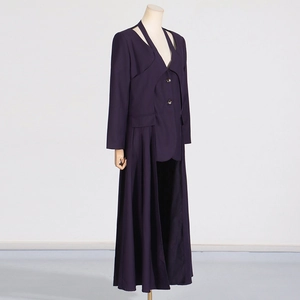 Detailed side view of deep purple trench coat featuring artistic pleated hem and cut-out collar