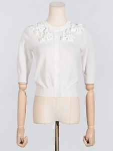 Elegant white knit cardigan with 3D floral appliques and round neck on a mannequin