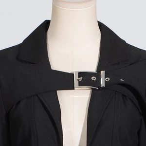 Detail of black blazer lapel with silver buckle strap decoration on a mannequin