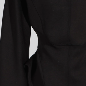 Detail view of premium black jacket featuring slim fit tailoring and high-quality fabric texture