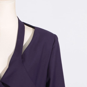 Detail of deep purple twill trench coat featuring a unique shoulder cutout and structured fabric