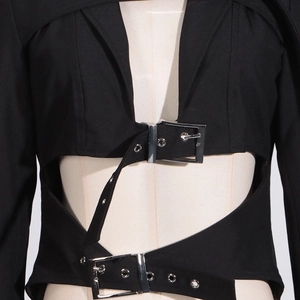 Detailed close-up of a black hollow-out blazer featuring stylish waist belt buckles