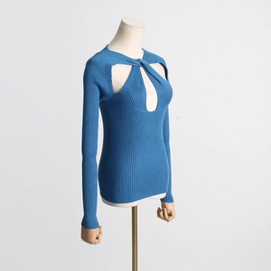 Detailed close-up of blue knit sweater showing twisted knot cutout and ribbed texture