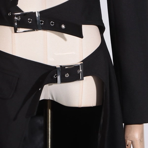 Detail view of black cut-out trench coat featuring creative waist buckles and metal eyelets