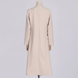 Back view of apricot mid-length trench coat showing tailored fit and seam details