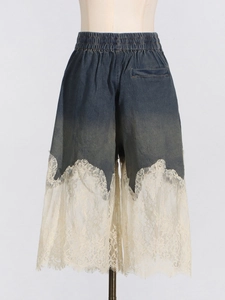 Lace-trimmed denim culottes with elastic waist and intricate floral embroidery detail