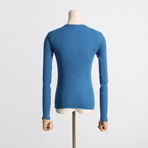 Detail view of navy blue ribbed knit sweater with crew neck and raglan sleeves