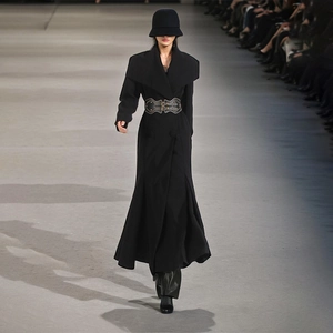 Detail of elegant black long coat featuring wide lapels and a leather waist cincher