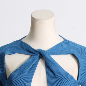 Detailed view of peacock blue ribbed knit sweater featuring a twist hollow neckline design