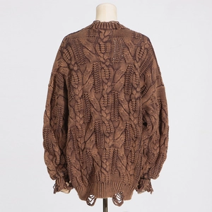 Detailed back view of brown oversized distressed knit sweater with chunky cable texture