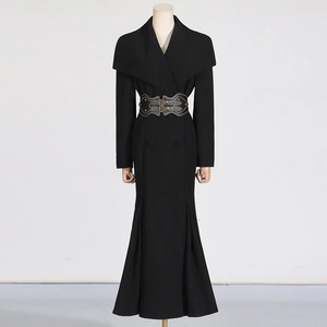Detailed view of the elegant wide waist belt with double metal buckles on a black coat