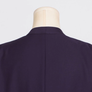 Detail view of the back collar and seam on a dark purple minimalist trench coat