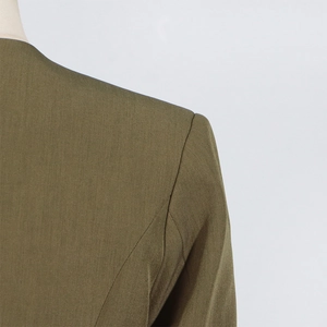 Detailed view of the olive green blazer's shoulder seams and high-quality tailoring