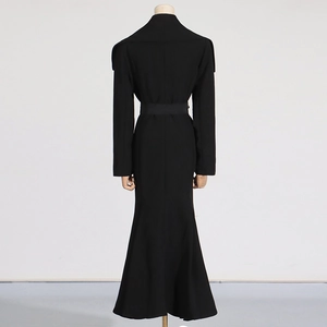 Detail view of the sleek waist belt and mermaid silhouette of the black long coat