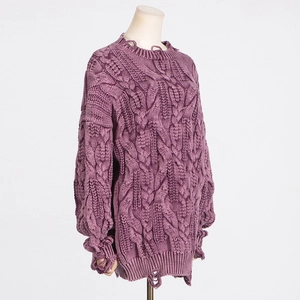 Detailed view of purple chunky cable knit sweater featuring distressed ripped hem details