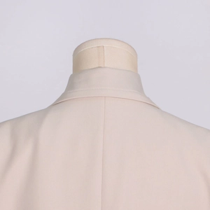 Detailed view of the back collar and twill texture on a beige British style trench coat