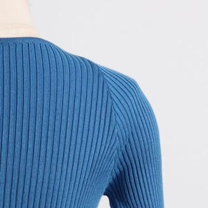 Detail of the stitching and rib-knit texture on the shoulder of this blue slim sweater
