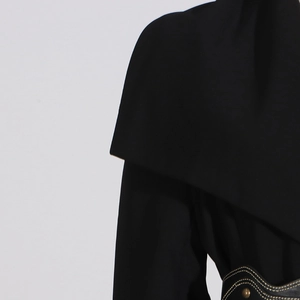 Detail of black trench coat collar and leather waist belt with bronze rivets and yellow stitching