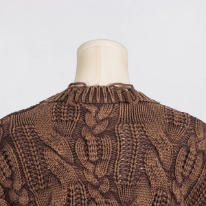 Detailed close-up of dark brown cable knit sweater showing textured ribbing and stitching