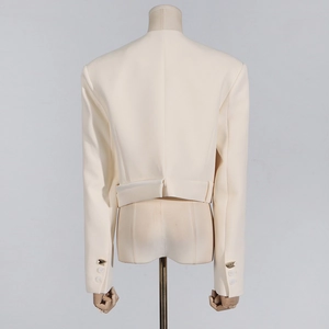 Back view of cream-white cropped blazer with sleeve button details and premium texture