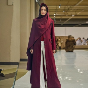 Detail of burgundy long hooded trench coat featuring a structured silhouette and single-breasted closure