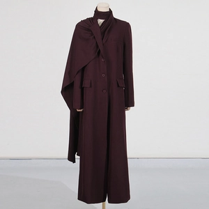 Detail of deep purple long coat featuring a unique scarf-style collar and smooth texture