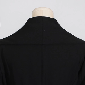 Close-up of symmetric collar and back stitching on this elegant black trench coat