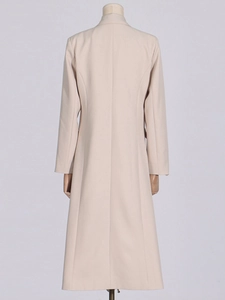 Classic beige long trench coat for women with straight fit and elegant back seam detail