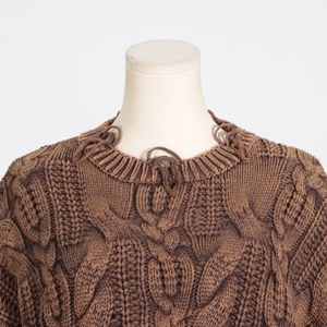 Detail of chunky cable knit sweater with unique ring collar accents in dark brown
