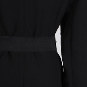 Detail of the high-waist elastic band and pleat design on the back of the black trench coat