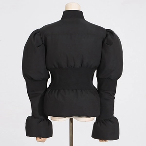 Détail d'une veste noire à col montant avec manches bouffantes et taille cintrée