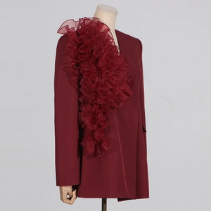 Detail eines burgunderroten Blazers mit 3D-Organza-Rüschen und taillierten Ärmeln
