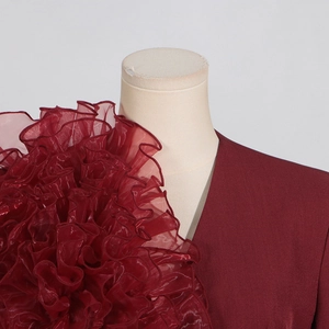 Detailansicht eines weinroten Blazers mit elegantem Rüschen-Tüll an der Schulterpartie