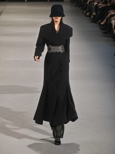 Elegant black long trench coat with wide lapels, corset waist, and fisheye hem design