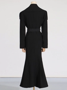 Back view of a sleek black long-sleeve trench coat featuring a cinched waist and wide belt